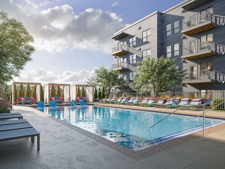 Pool with chaise lounges at V2 Apartments in Chelsea MA